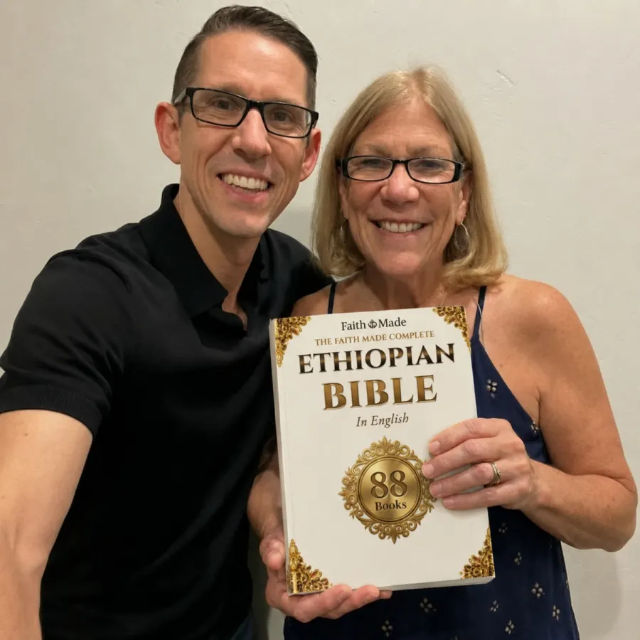 A couple holding the Faith Made Complete Ethiopian Bible