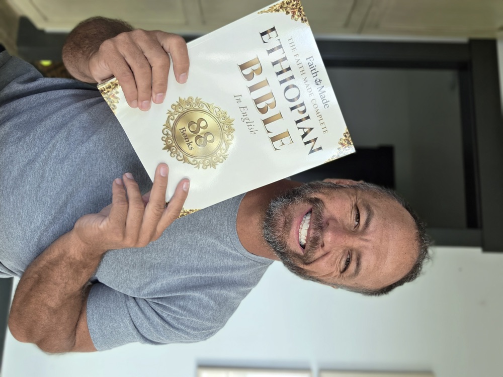Matt K. holding The Faith Made Complete Ethiopian Bible